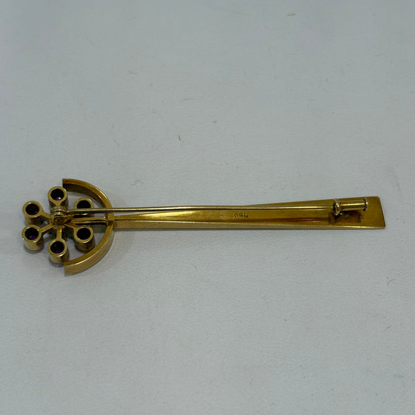 Goldbrosche mit Brillant umgeben von Rubinen