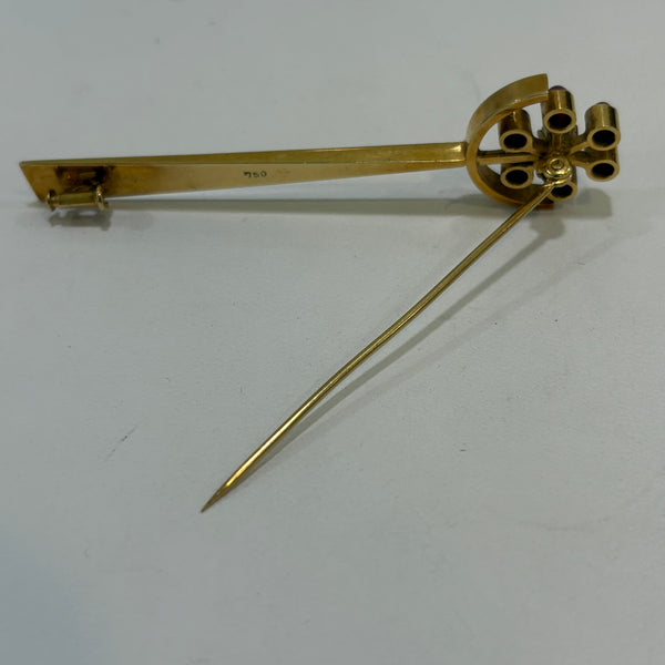 Goldbrosche mit Brillant umgeben von Rubinen